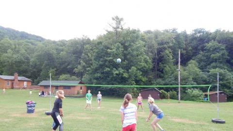 Group of youth playing volleyball.
