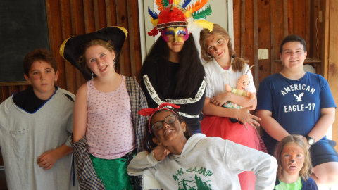 Campers in costume pose together before a drama skit.
