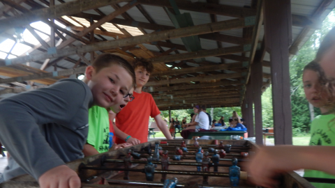 Youth playing Foosball.