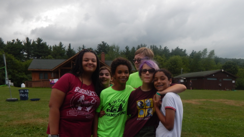 Campers standing close together in a group posing for the camera.