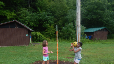 two campers playing tether ball.