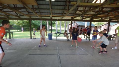 campers play four square in the camp pavilion 