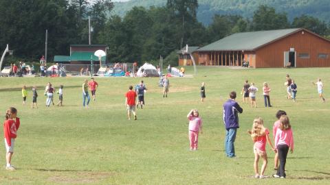 campers play outside in the field at camp 