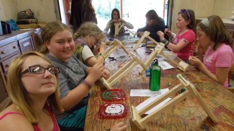 campers working on beading arts and crafts projects