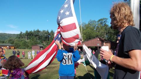 campers raising flag during flag ceremony 