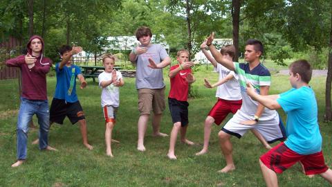campers practicing Tai Chi outside at camp 