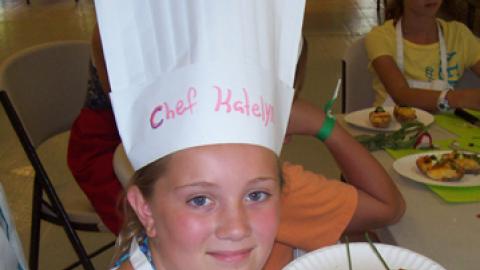 Chef Katelyn holding up a culinary creation.