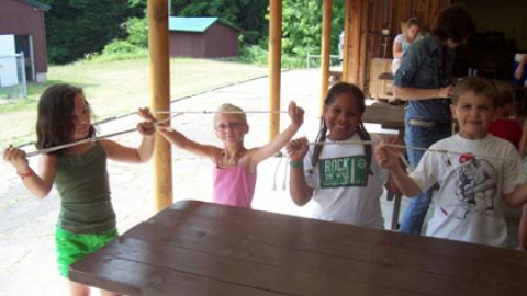 Day campers hold up their rope projects. 