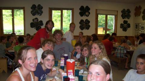 Table of campers and counselors during a meal.