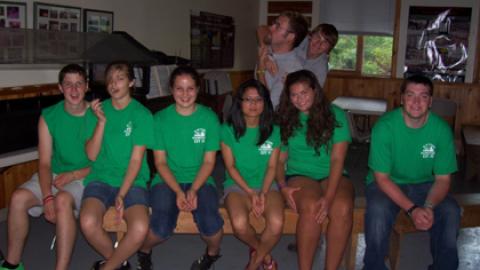 group of counselors looking at the camera and smiling during a meeting.