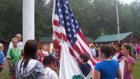 Youth and campers gathered together to raise the American and 4-H Flag.
