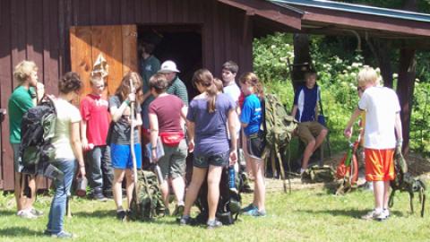 group of campers with their hiking bags preparing to head out into Lennox forest.