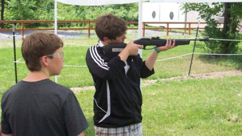 Youth taking aim with air rifle.