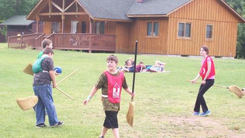 campers playing Quidditch with brooms 