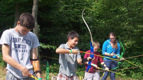 Youth load their bows with arrows. 