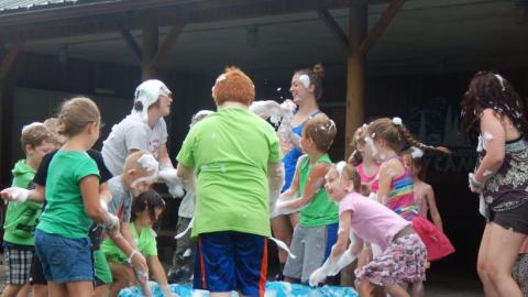 campers grab bubbles from small pool and throw them at each other 