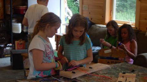 Youth working on bead crafts. 