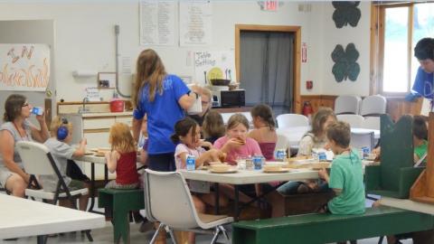 Youth eat a meal in the camp dining hall. 