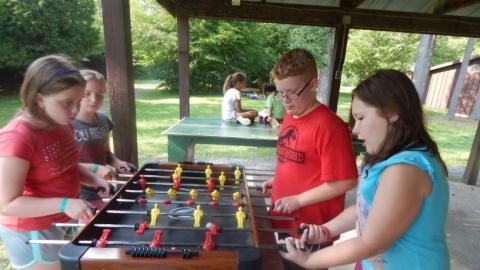 Youth playing a friendly game of Foosball. 