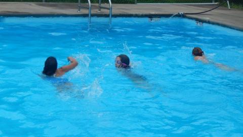 Youth swimming in the camp pool. 