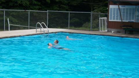 campers swimming in the pool.