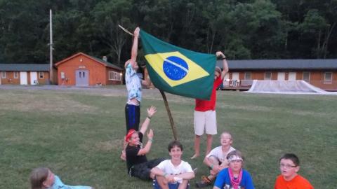 campers hanging flag on stick 