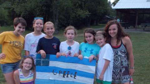 campers posing with handmade Greek flag