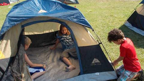 campers set up tent, preparing for back packing 