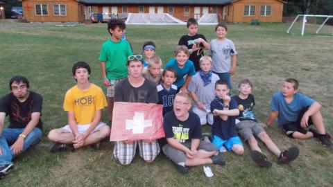 campers posing with handmade Switzerland flag.