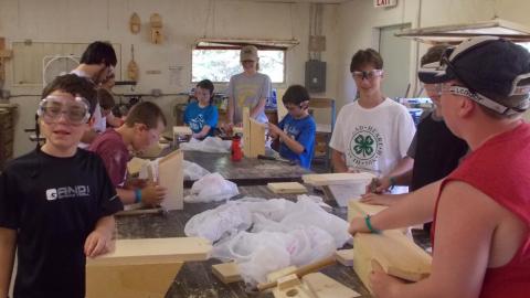 campers completing birdhouse made in the camp wood shop 