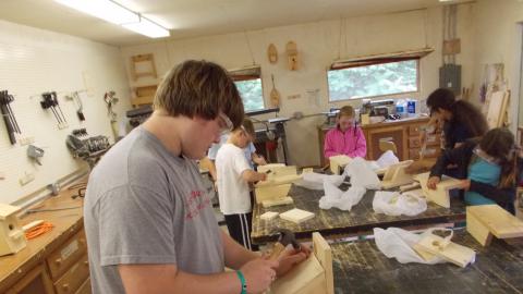 campers completing birdhouses made in the camp wood shop 