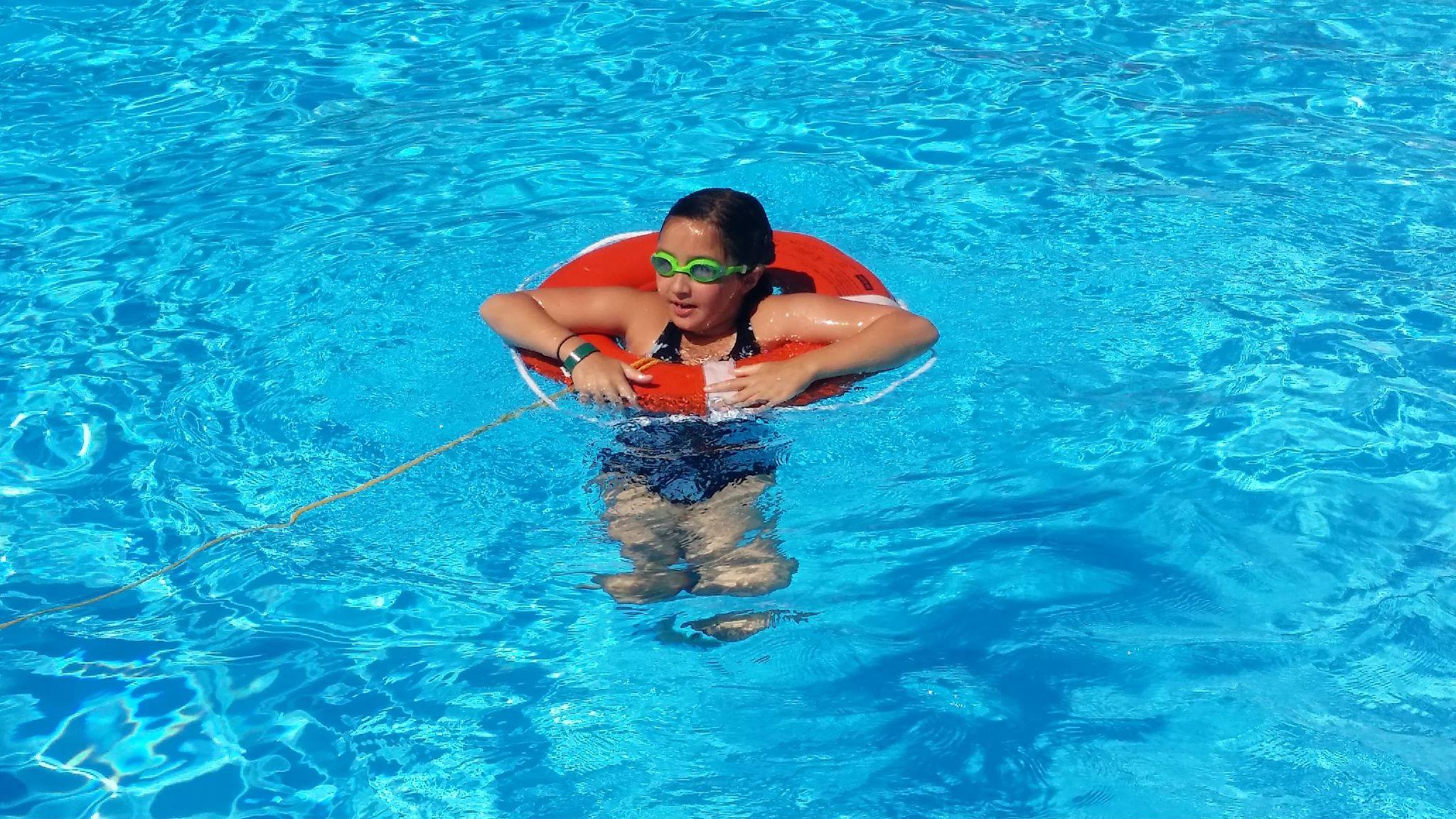 Girl floating in pool